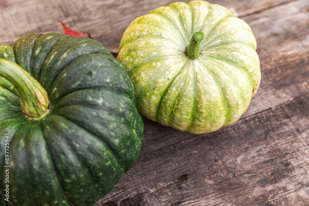 Autumnal Background. Natural autumn fall view pumpkins on wooden background. Inspirational october or september wallpaper. Change of seasons ripe organic food concept. Halloween party Thanksgiving day Autumnal Background. Natural autumn fall view pumpkins on wooden background. Inspirational october or september wallpaper. Change of seasons ripe organic food concept. Halloween party Thanksgiving day