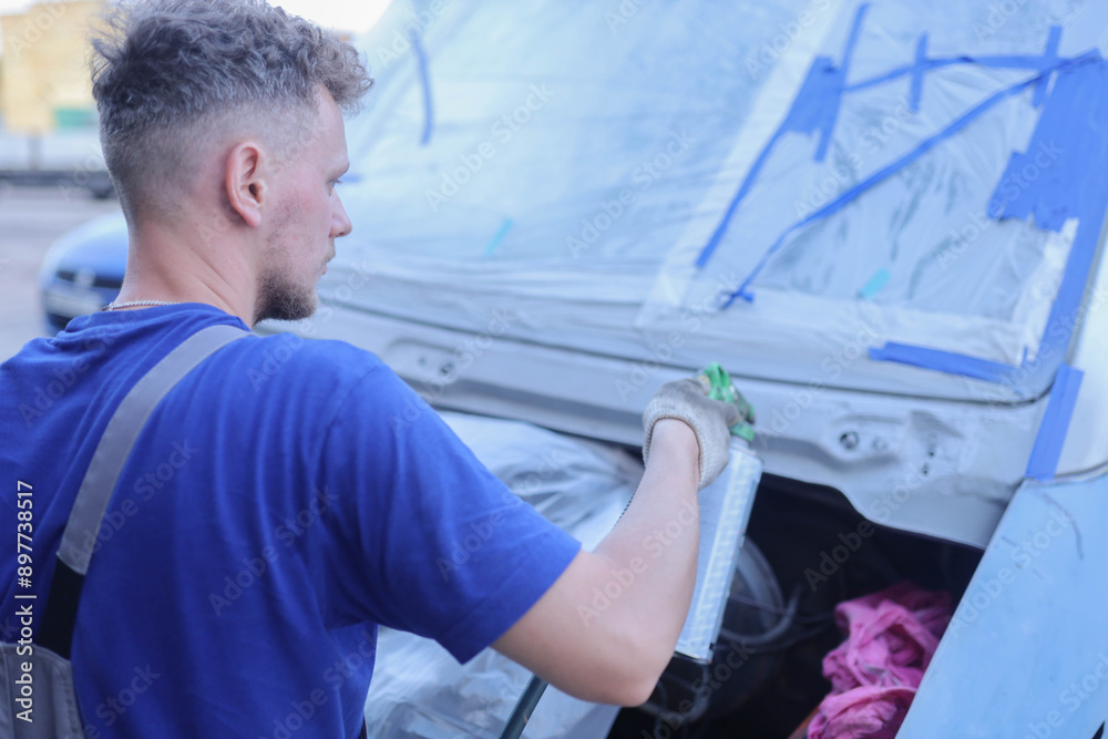 man paints van white, car painting