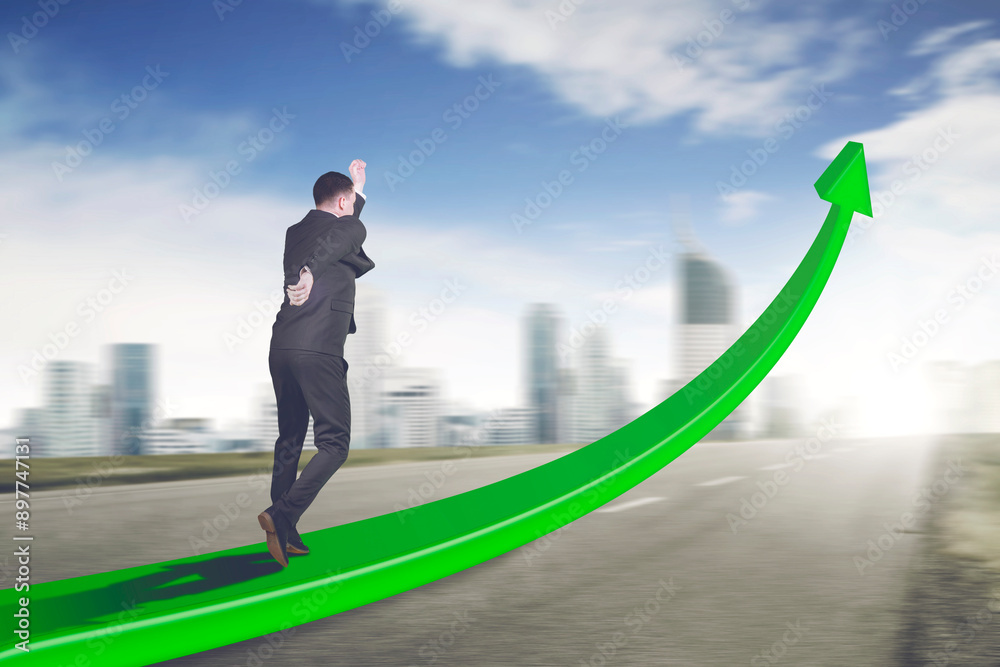 Fototapeta premium Rear view of male manager running fast on the upward arrow on the road