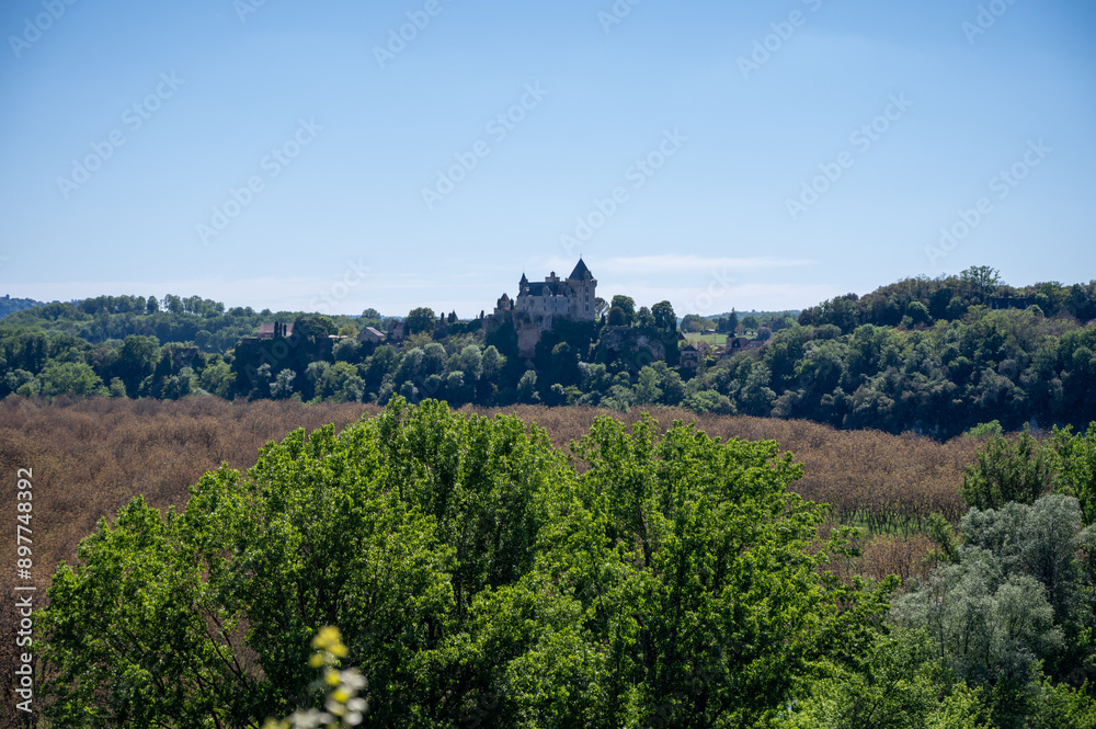Driving along Dordogne river near .La Roque-Gageac village located in Dordogne department in southwestern France Driving along Dordogne river near .La Roque-Gageac village located in Dordogne department in southwestern France
