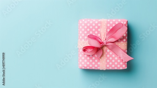 Adorable gift box with pink polka-dot wrapping and pink ribbon