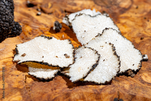 Slices of Italian black summer truffle, tasty aromatic mushroom, close up