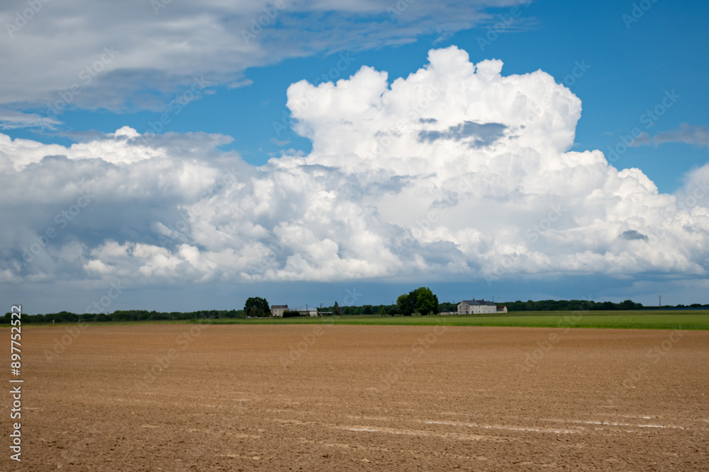 French country landscape with fields and white clouds on blu sky French country landscape with fields and white clouds on blu sky