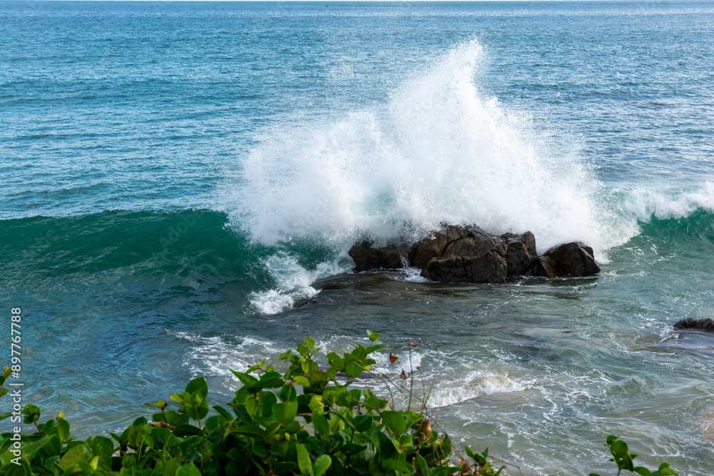 Fototapeta premium Strong sea waves breaking on a rock at the seaside. Live nature. Environment.