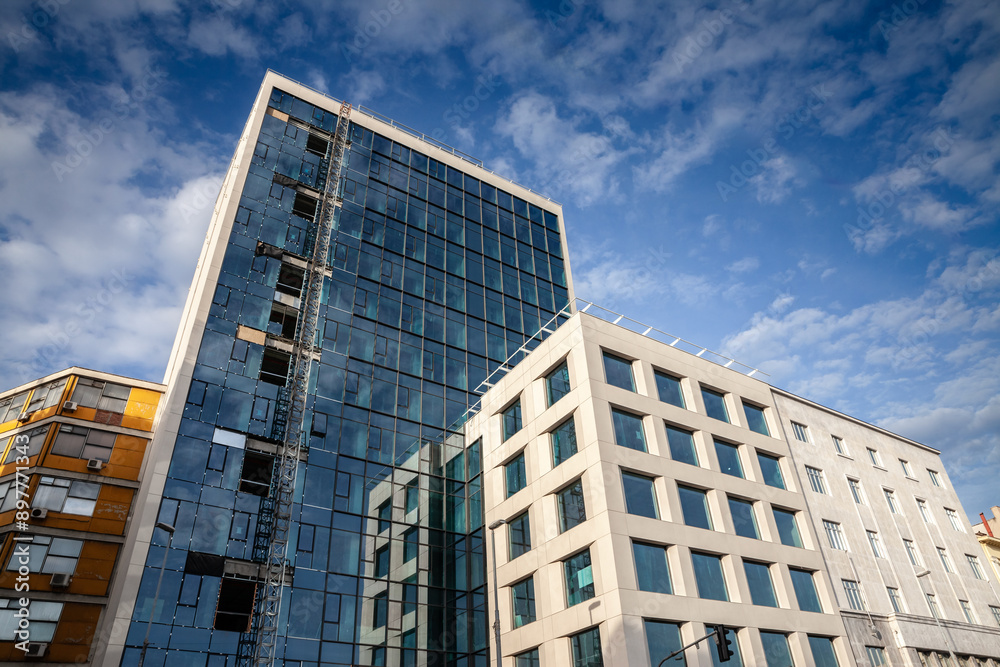 Modern Business High Rise Building Under Construction in Belgrade with a blue sky, in the center business district, with real estate opportunities around;