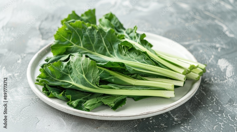 Turnip greens on white plate on ceramic surface Turnip greens on white plate on ceramic surface