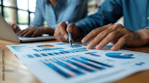 Analyzing Market Data: Two Confident Businesspeople Pointing to Graphs and Charts to Plan New Sales Strategies and Increase Production Capacity