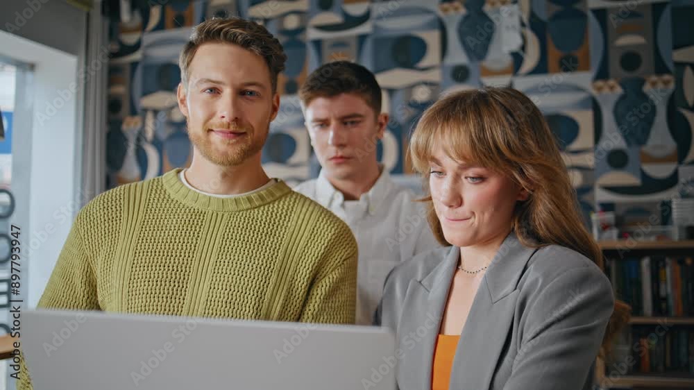 Startup team posing camera in conference room portrait. People looking laptop Startup team posing camera in conference room portrait. People looking laptop