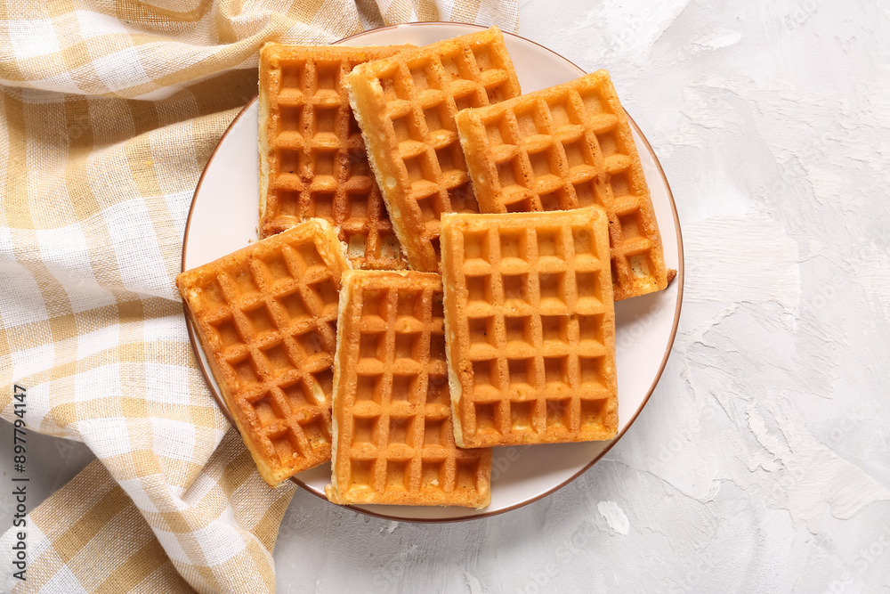 Plate with tasty Belgian waffles on grey background Plate with tasty Belgian waffles on grey background