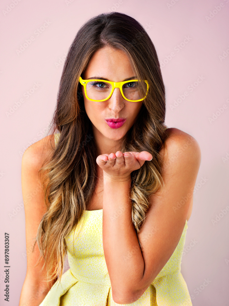 Blow, kiss and girl with glasses in portrait for eye care in studio, clear vision and prescription lens for eyesight. Female person, gesture and pink background with spectacles for optometry wellness Blow, kiss and girl with glasses in portrait for eye care in studio, clear vision and prescription lens for eyesight. Female person, gesture and pink background with spectacles for optometry wellness