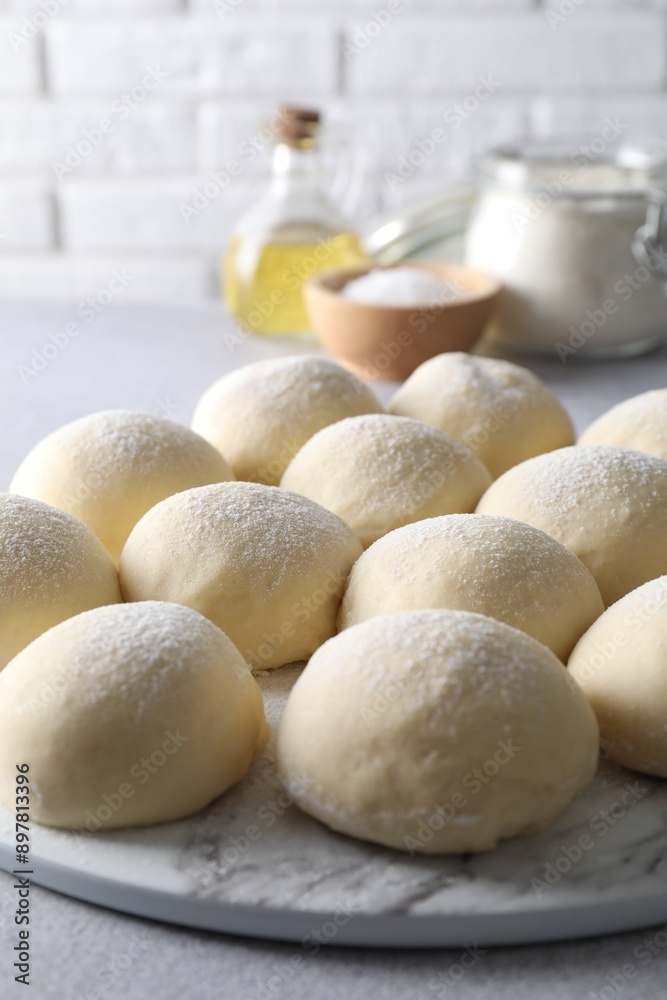 Raw dough balls on light grey table, closeup Raw dough balls on light grey table, closeup