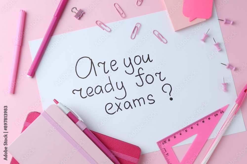 Paper note with question Are You Ready For Exams and stationery on pink background, flat lay Paper note with question Are You Ready For Exams and stationery on pink background, flat lay