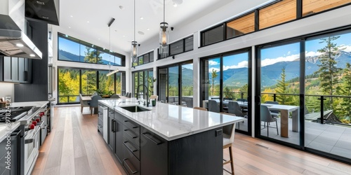 A luxury kitchen featuring panoramic mountain views through large windows, with a modern design, open concept, and high-end appliances