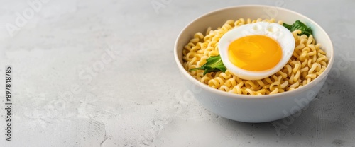 Overhead image of instant noodle bowl with egg and greens, minimal setup, copy space, natural lighting