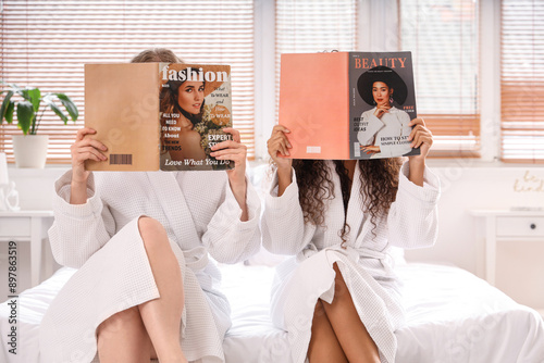 Young women reading magazin...