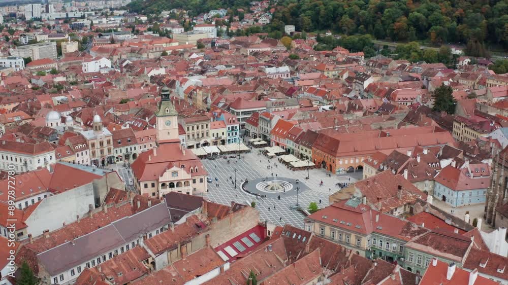A european city with red rooftops and a central square surrounded by buildings, aerial view A european city with red rooftops and a central square surrounded by buildings, aerial view