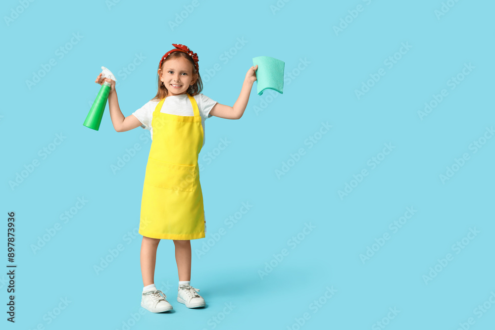 Cute little happy girl with bottle of detergent and rag on blue background Cute little happy girl with bottle of detergent and rag on blue background