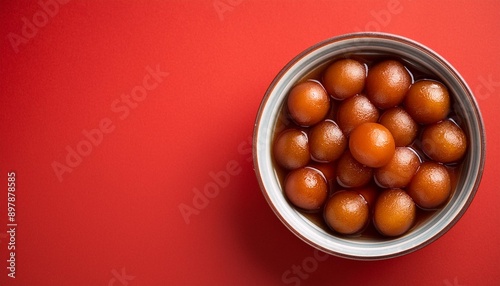 Indian sweet food gulab jamun on red background photo