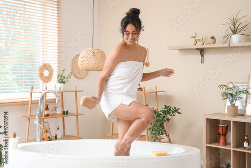 Happy young woman in towel ...