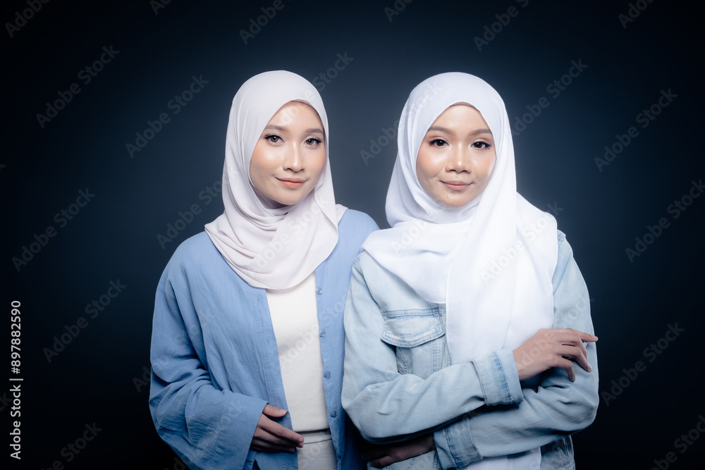 Portrait of a beautiful Malaysian and Indonesian Muslim young women wearing modern and casual wear with hijab on isolated studio background. Modern hijab fashion and beauty concept Portrait of a beautiful Malaysian and Indonesian Muslim young women wearing modern and casual wear with hijab on isolated studio background. Modern hijab fashion and beauty concept