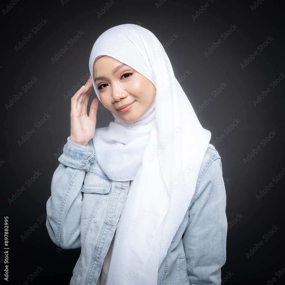 Portrait of a beautiful Malaysian and Indonesian Muslim young women wearing modern and casual wear with hijab on isolated studio background. Modern hijab fashion and beauty concept Portrait of a beautiful Malaysian and Indonesian Muslim young women wearing modern and casual wear with hijab on isolated studio background. Modern hijab fashion and beauty concept