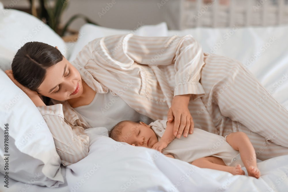 Mother with her little baby lying in bedroom Mother with her little baby lying in bedroom