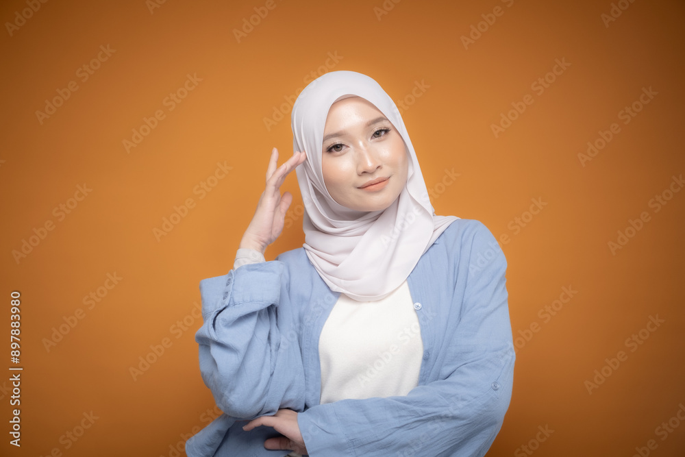 Portrait of a beautiful Malaysian and Indonesian Muslim young women wearing modern and casual wear with hijab on isolated studio background. Modern hijab fashion and beauty concept Portrait of a beautiful Malaysian and Indonesian Muslim young women wearing modern and casual wear with hijab on isolated studio background. Modern hijab fashion and beauty concept