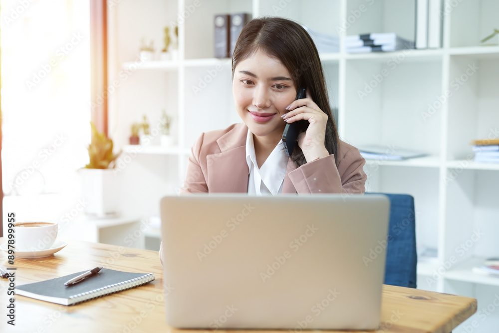 Asian business woman Use a laptop computer and work at the office ready. plan to analyze financial reports Asian business woman Use a laptop computer and work at the office ready. plan to analyze financial reports