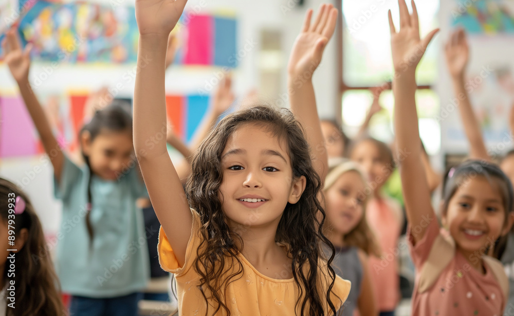 Children raising hands in a classroom with excitement. Children raising hands in a classroom with excitement.