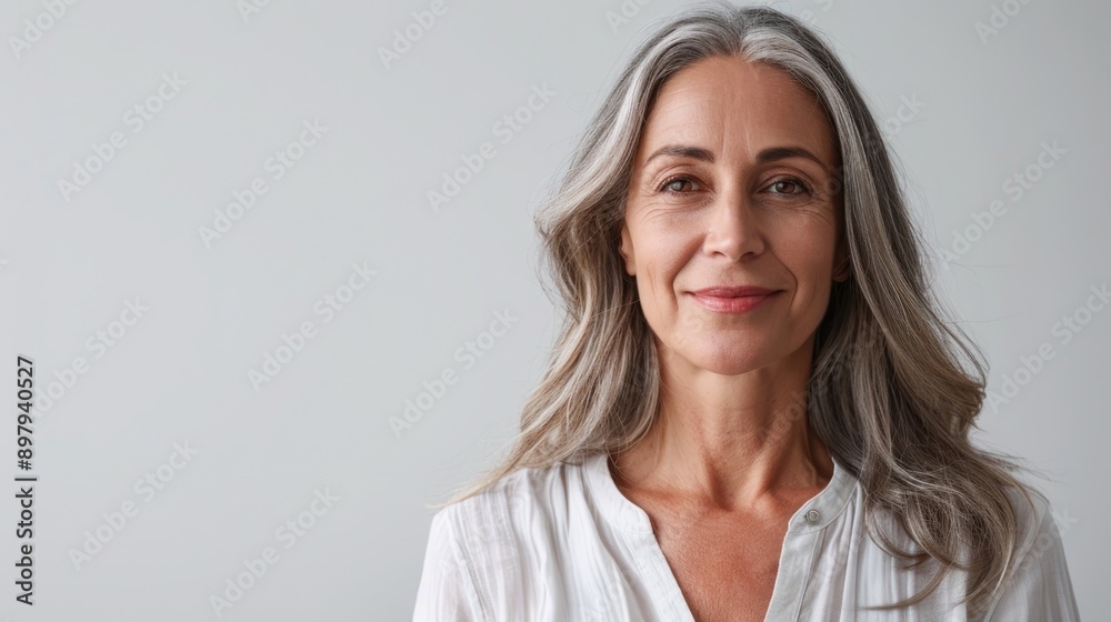 Middle-aged woman presenting with a friendly smile, half-body shot against a solid white background with plenty of copy space Middle-aged woman presenting with a friendly smile, half-body shot against a solid white background with plenty of copy space