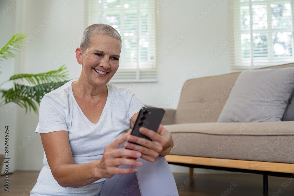 Elderly Woman Using Smartphone While Practicing Yoga at Home, Combining Modern Technology with Healthy Lifestyle Elderly Woman Using Smartphone While Practicing Yoga at Home, Combining Modern Technology with Healthy Lifestyle
