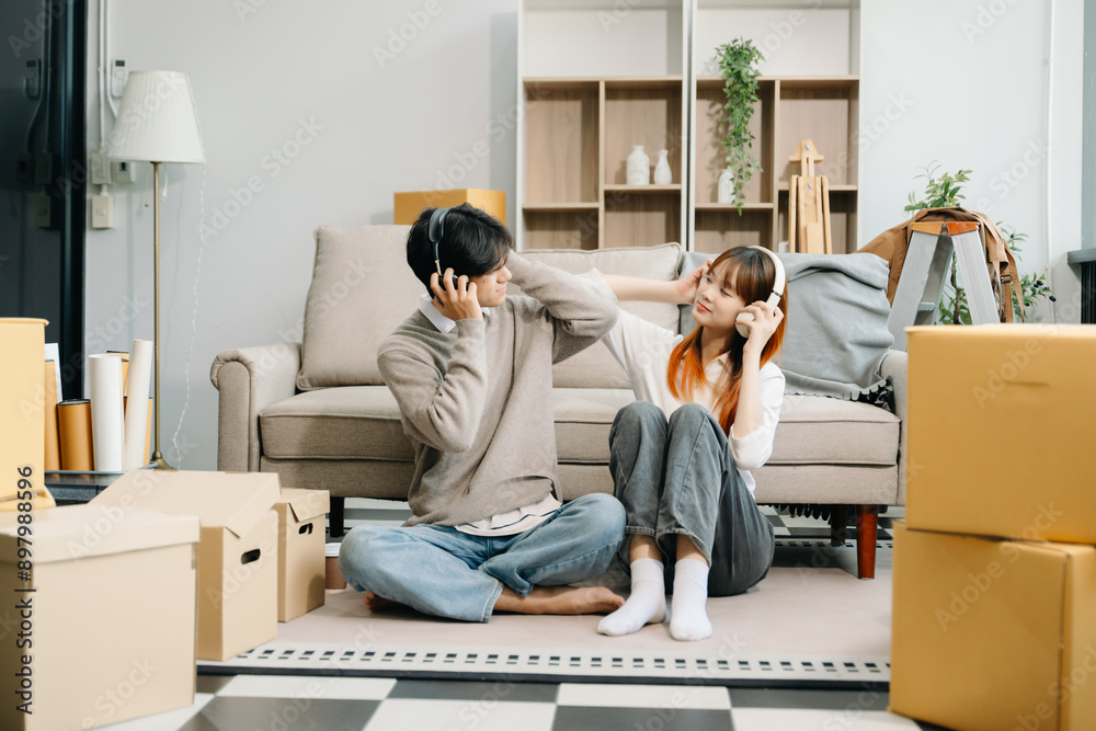 Happy asian young attractive couple man and woman with big boxes moving into a new house, new apartment for couple Happy asian young attractive couple man and woman with big boxes moving into a new house, new apartment for couple