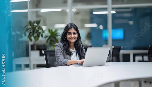 young indian won working on laptop