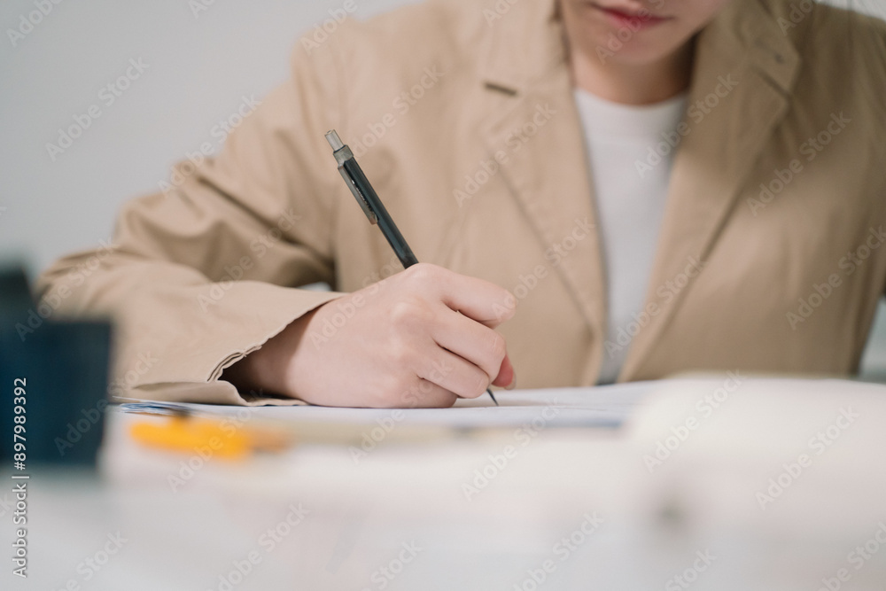 In her architecture office, the woman architect meticulously drafts a blueprint for a project, working with precision and creativity in engineering and design drawing. In her architecture office, the woman architect meticulously drafts a blueprint for a project, working with precision and creativity in engineering and design drawing.
