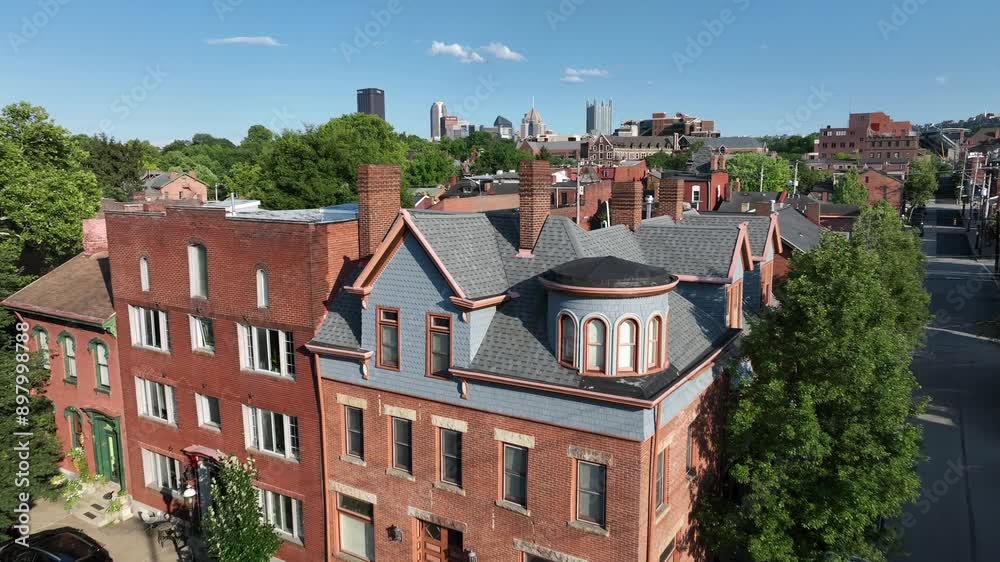 Historic houses and Buildings With red brick chimney in suburb of Pittsburgh City. Skyline with skyscraper towers in Background.Sunny day with blue sky in summer. Aerial forward shot between chimneys. Historic houses and Buildings With red brick chimney in suburb of Pittsburgh City. Skyline with skyscraper towers in Background.Sunny day with blue sky in summer. Aerial forward shot between chimneys.