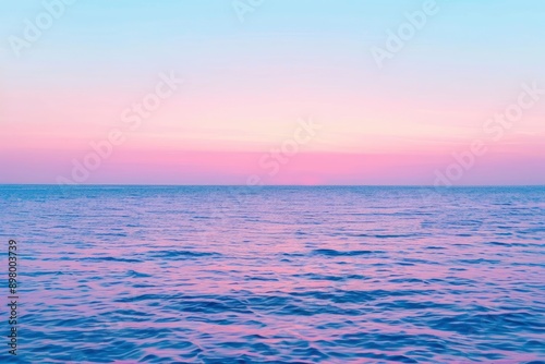 Clear blue sky sunset with glowing pink and purple horizon on calm ocean seascape background. Picturesque - generative ai