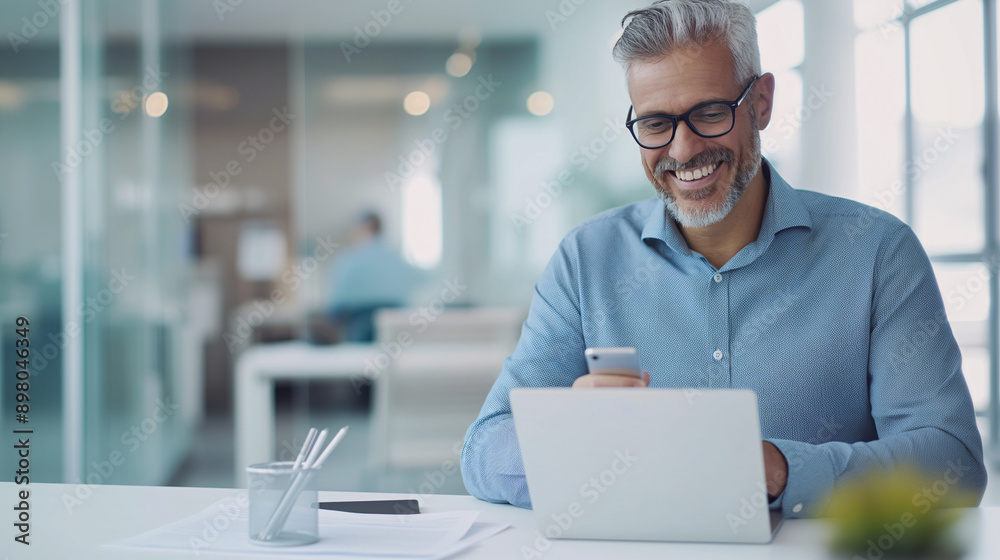 Smiling businessman using smartphone in modern office setting Smiling businessman using smartphone in modern office setting