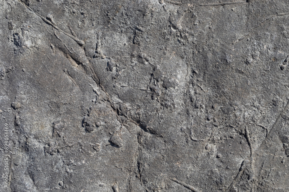 Sea-worn stone texture on a wild coastal beach. Sea-worn stone texture on a wild coastal beach.