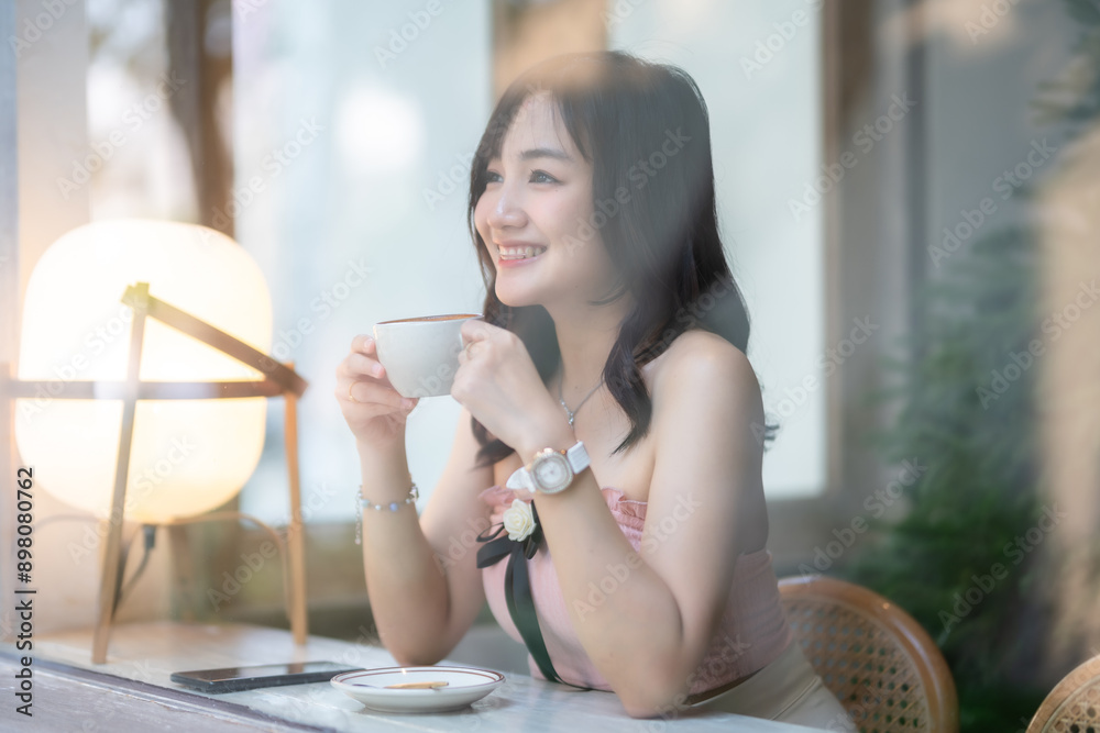 Portrait of beautiful happy Smiling asian woman relaxing sitting in cafe interior in coffee shop background,Business Lifestyle summer holiday concept Portrait of beautiful happy Smiling asian woman relaxing sitting in cafe interior in coffee shop background,Business Lifestyle summer holiday concept
