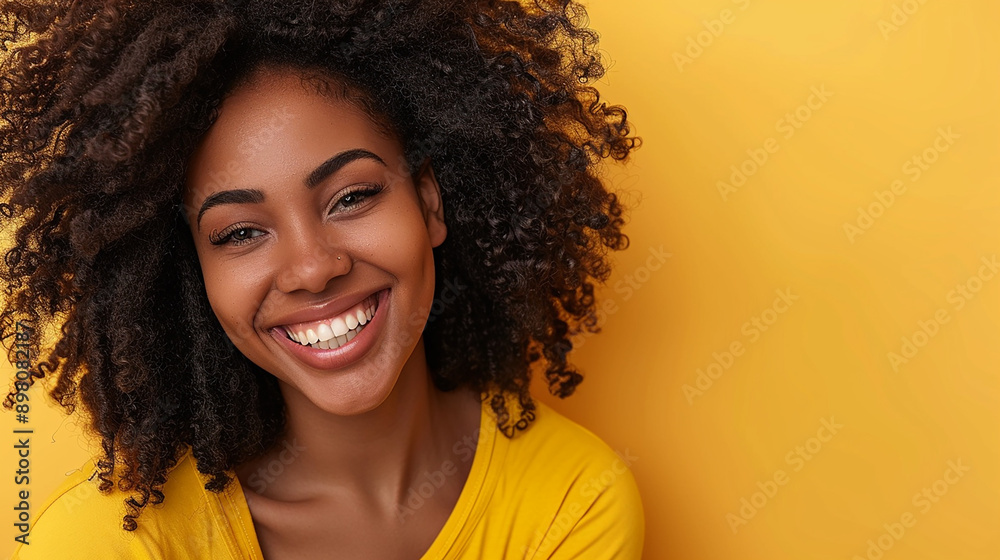 A joyful woman with curly hair smiling brightly against a vibrant yellow background, exuding happiness and positivity, with space for text. A joyful woman with curly hair smiling brightly against a vibrant yellow background, exuding happiness and positivity, with space for text.