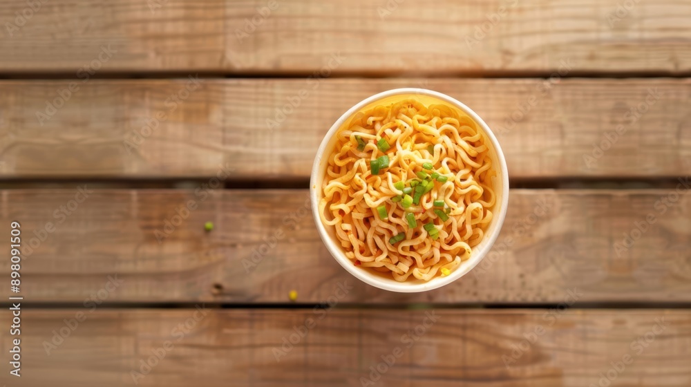 Aerial View of Spicy Noodles on Wooden Table in Serene Outdoor Setting Aerial View of Spicy Noodles on Wooden Table in Serene Outdoor Setting