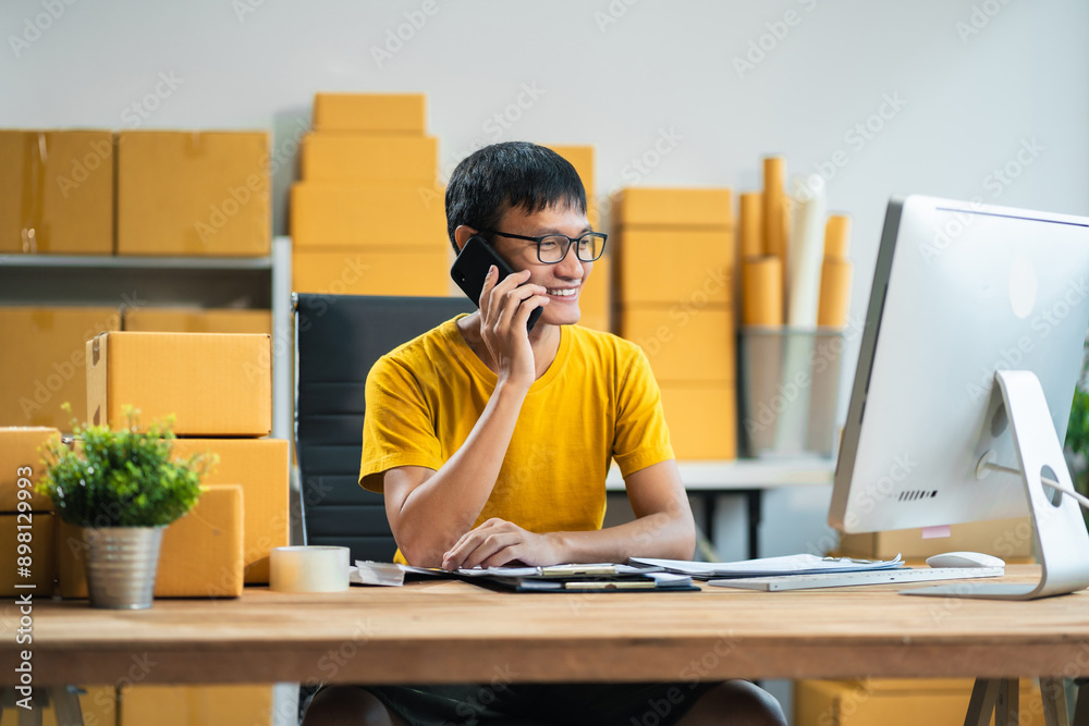 Successful male start up online seller at workplace. small business entrepreneur SME or freelance asian man working with box at home. Successful male start up online seller at workplace. small business entrepreneur SME or freelance asian man working with box at home.