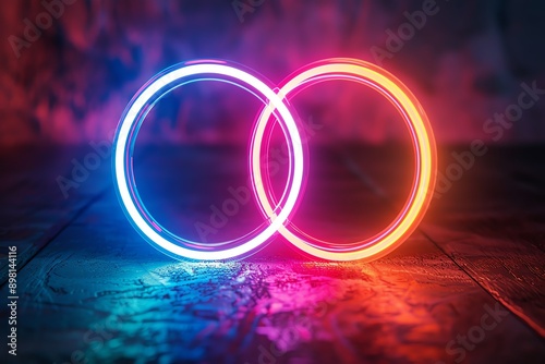 Two glowing neon rings intersect against a dark background, creating a vibrant and futuristic visual effect.