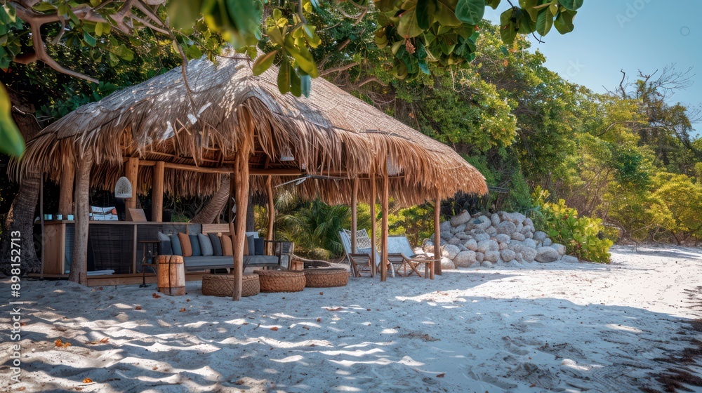 Fototapeta premium secluded beach pavilion set up as a temporary office, with eco-friendly materials and a thatched roof