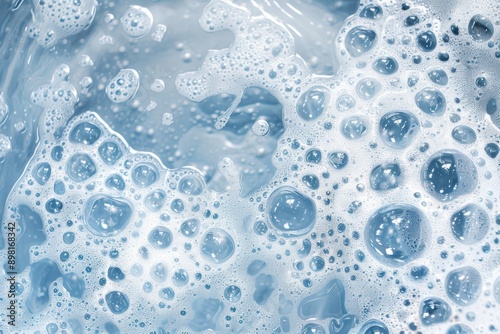 Detergent foam bubbles on blue surface