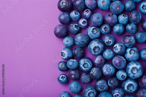 Blueberries on a violet background, view from above, empty space for text
