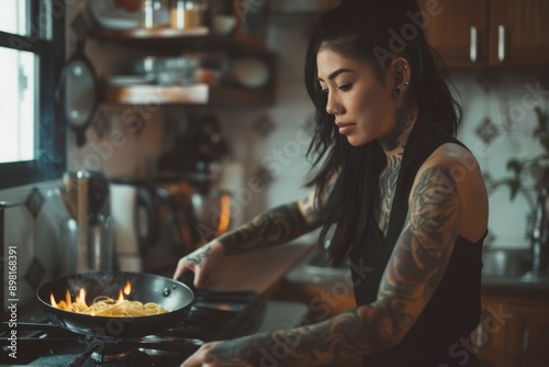 Young asian woman with tattoos on her arms cooks pasta on a gas stove