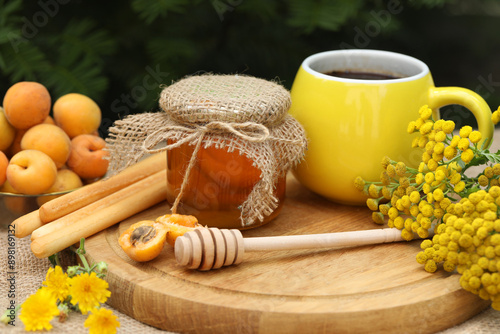 Summer still life picture with coffee, honey, apricots and yellow flowers  photo