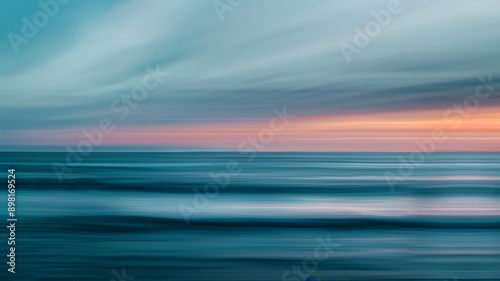 Abstract background wallpaper. Blurred image of the sky at sunset over waves in blue and teal colors, capturing motion blur and light rays creating a dreamy effect