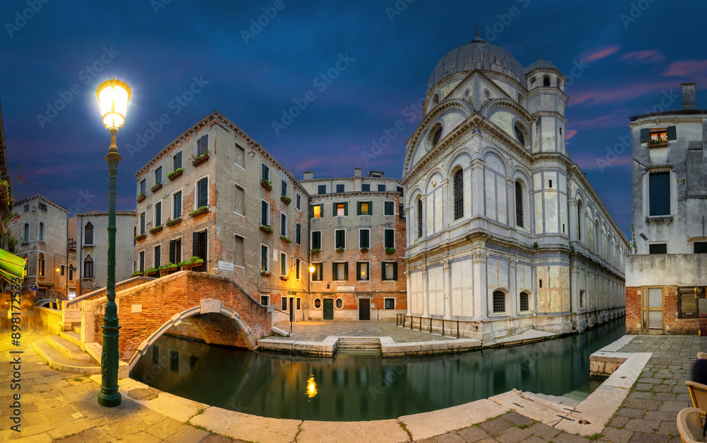 Venice, Italy. Wide angle HDR-panorama with Church of Saint Mary of Miracles at dusk